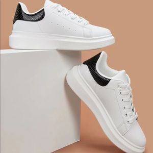 White sneakers with snakeskin design on back